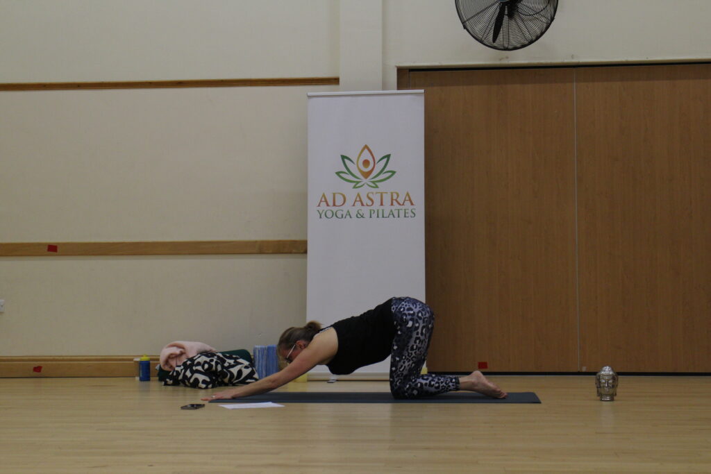 Jayne of Ad Astra Yoga and Pilates, in extended cow pose.